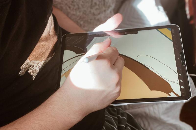 Digital artist drawing on a tablet.