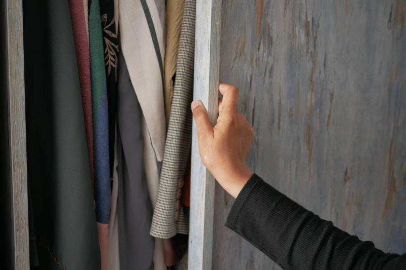 Closing closet on winter coats. 