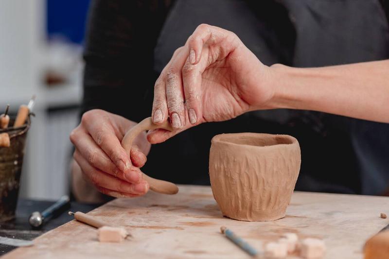 Potter making a cup out of clay.