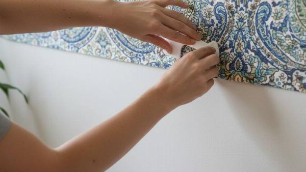 Hands hiding the seam by layering sheets.