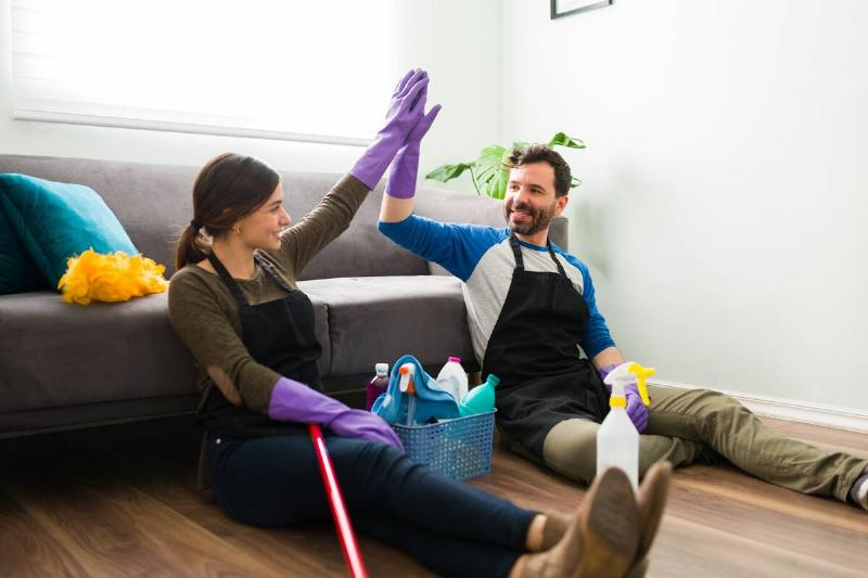 Couple congratulating each other after cleaning. 