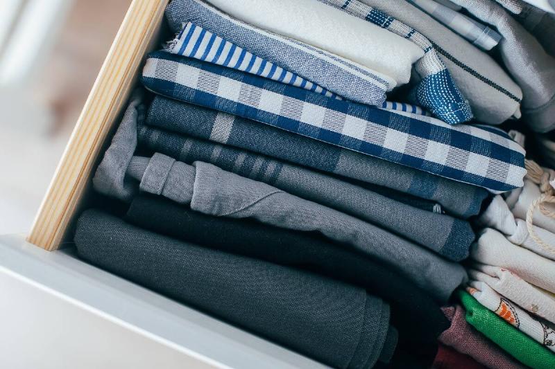 Clothes stacked vertically in a drawer. 