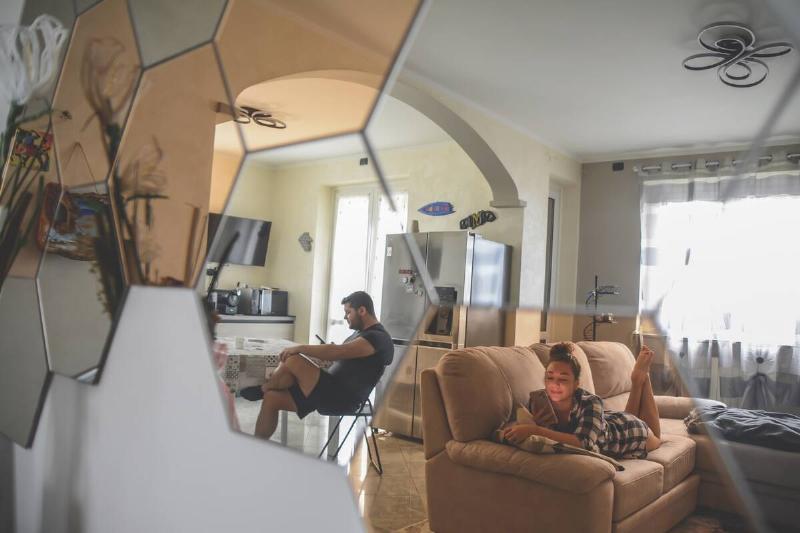 Mirror reflecting people using their phones.