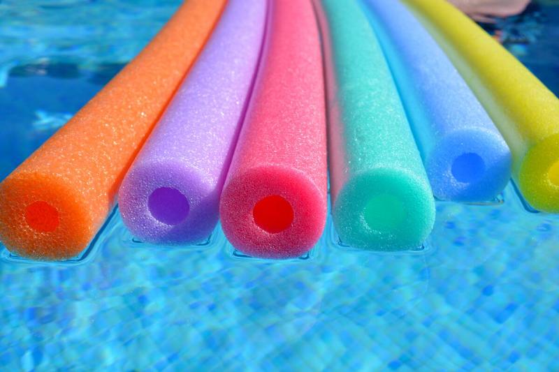 Pool noodles in a pool.