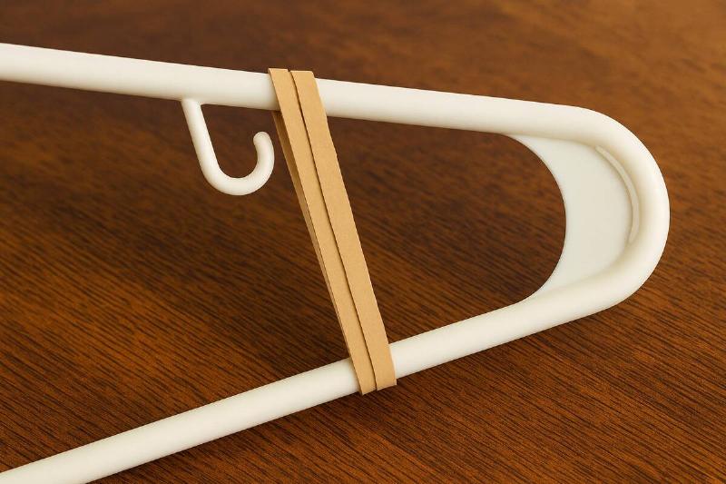 A rubber band wrapped around a hanger.