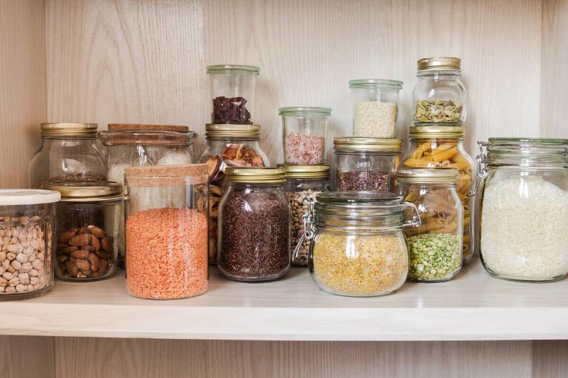 Glass jars used as pantry storage for dried goods.
