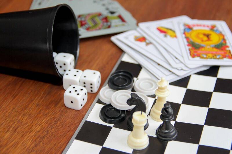Playing cards, dice and a chess board.