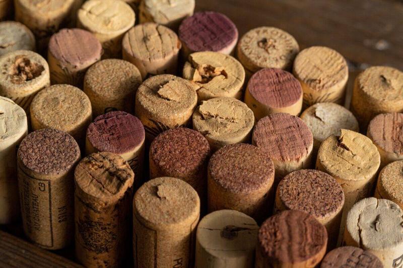 A variety of wine corks arranged on a wooden table.