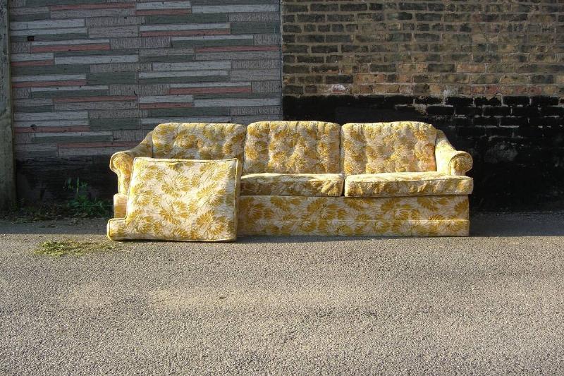 An old couch on the side of the road.