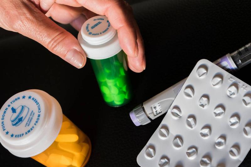Generic medications in pill bottles. 