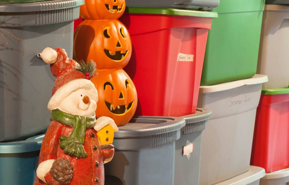 Decorations stored in hard plastic bins. 