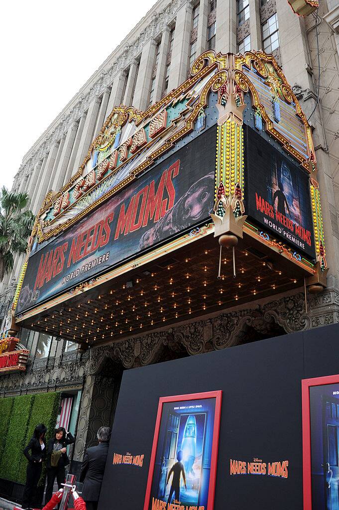 Exterior of a movie theater. The banner is promoting the film 'Mars Needs Moms'