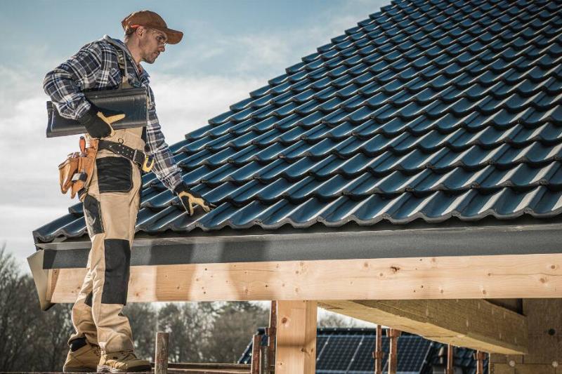 A contractor inspecting a roof.