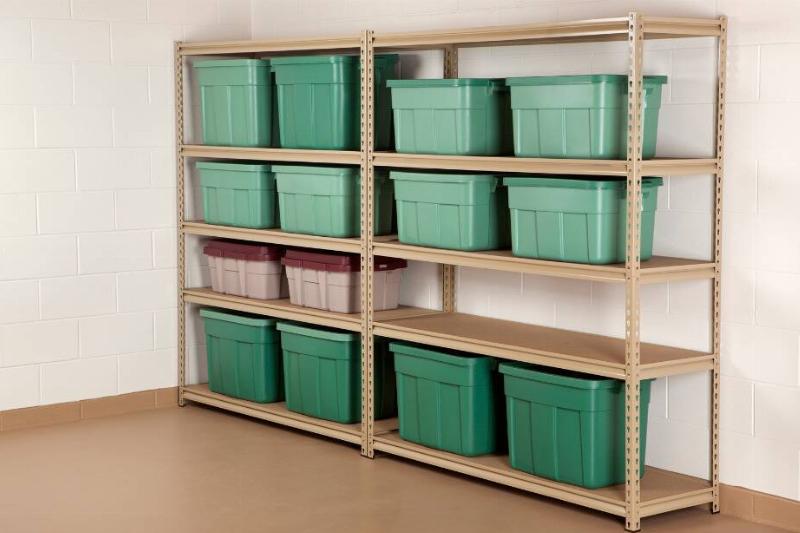 Shelves for storage with green bins on them. 