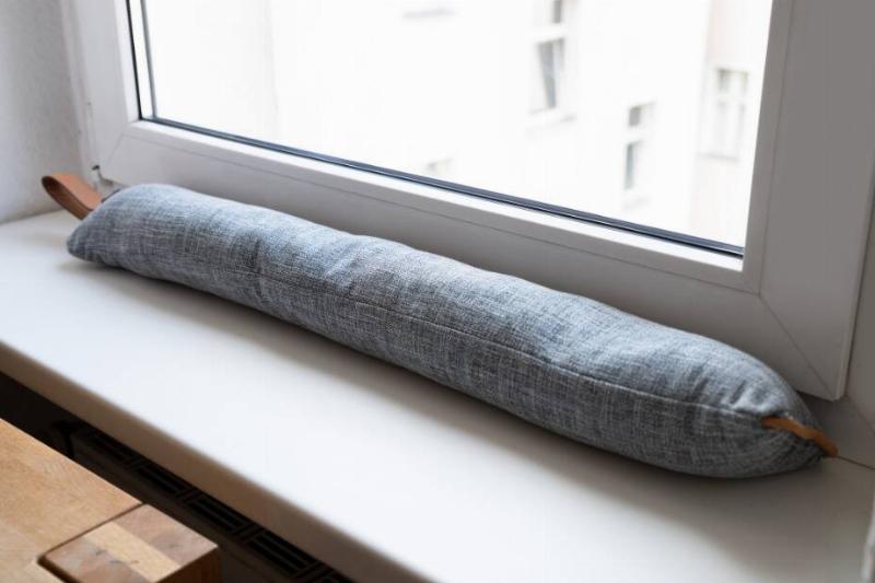A draft excluder by a window. 