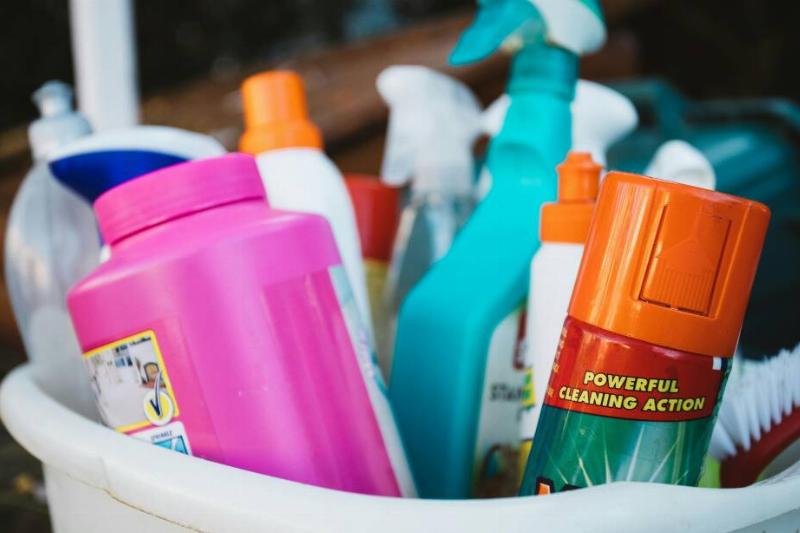 Cleaning supplies in basket that are each labeled. 