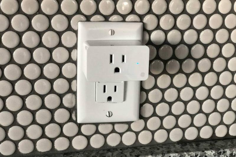A smart home plug in an outlet. 