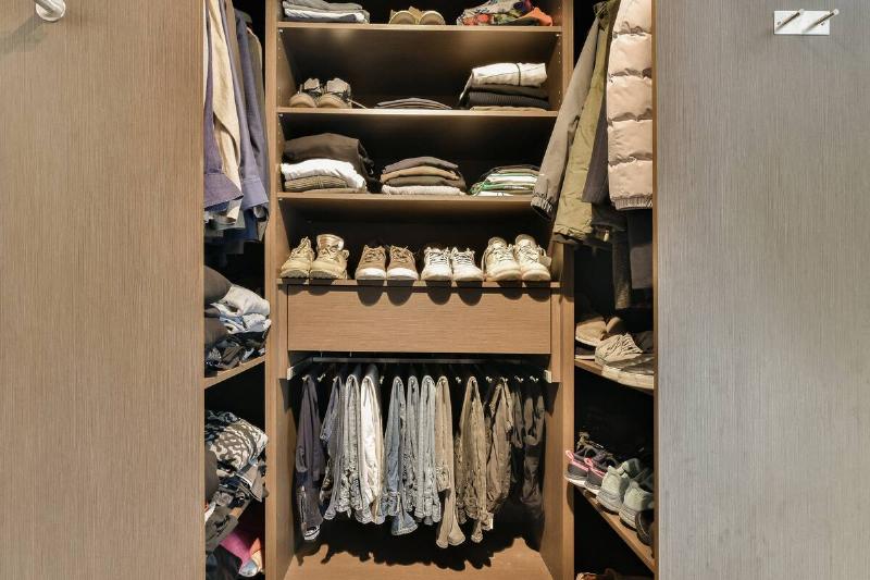 A dark closet filled with things.