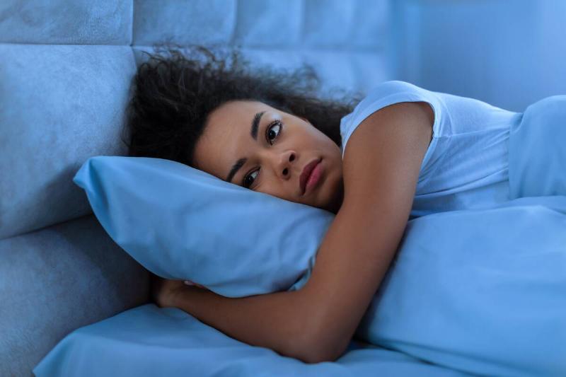 Woman laying awake unable to sleep. 