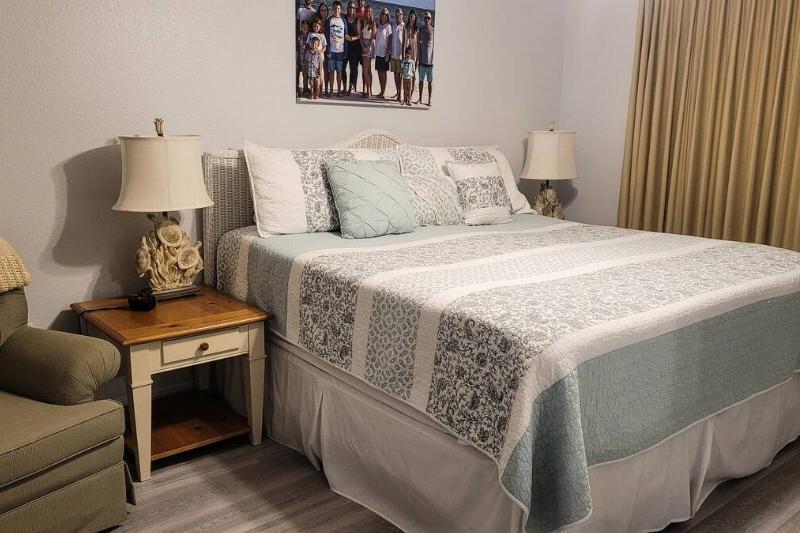 A bed made up in a guest room. 