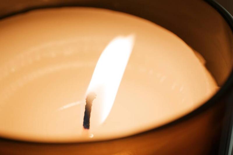 The flame of a candle being blown by a draft. 