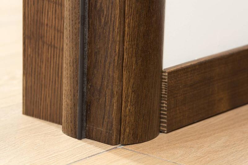 Close-up detail of brown wooden door frame. 