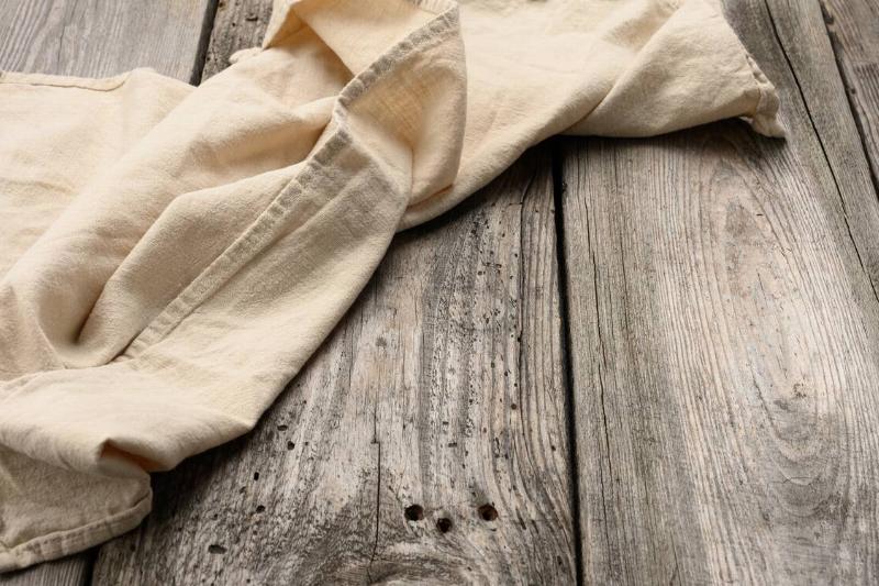 Old beige towel on a table. 