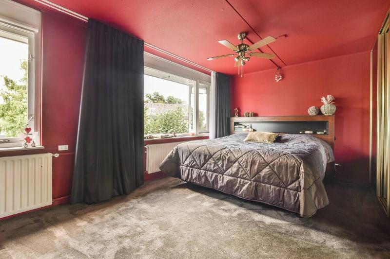 A bedroom painted bright red.