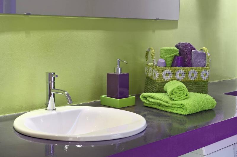 Purple and green themed bathroom. 
