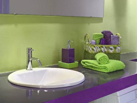 Purple and green themed bathroom. 