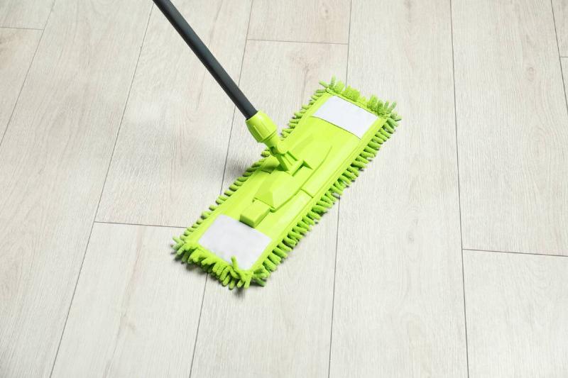 Microfiber mop on wooden floor.