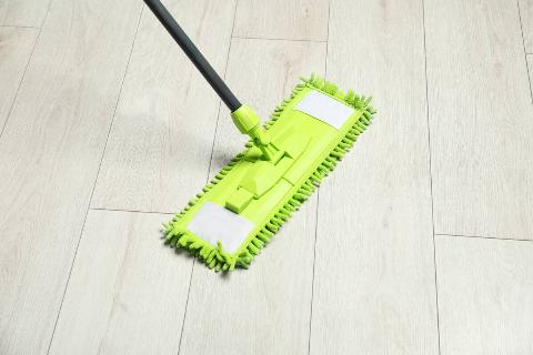 Microfiber mop on wooden floor.