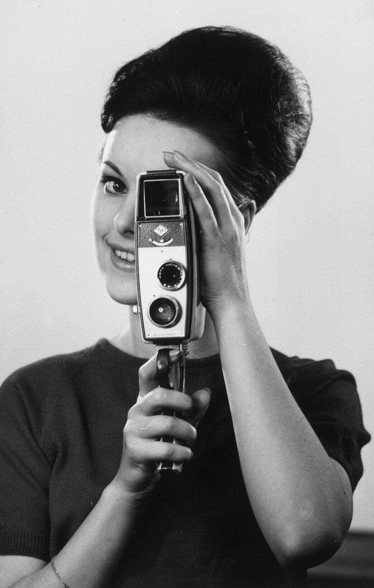 Woman holding an Agfa movie camera