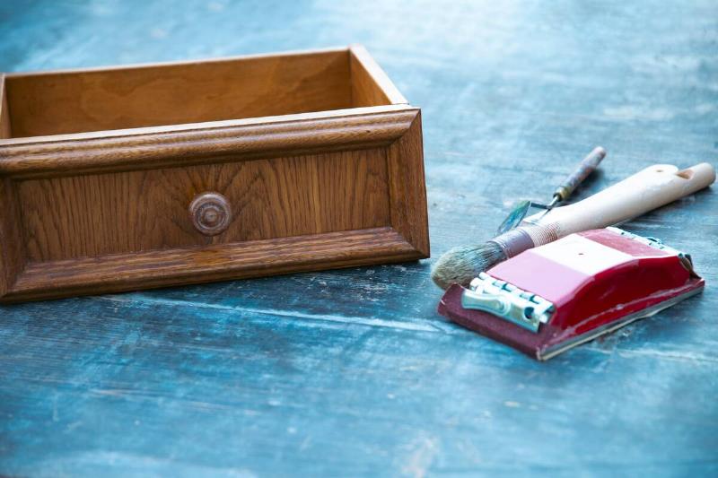 A drawer sitting on a drop cloth. 