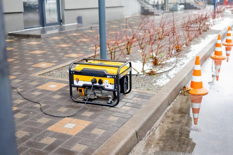 A generator placed on the sidewalk.