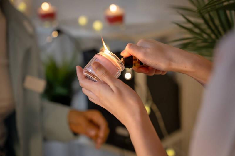 A woman lighting a candle.