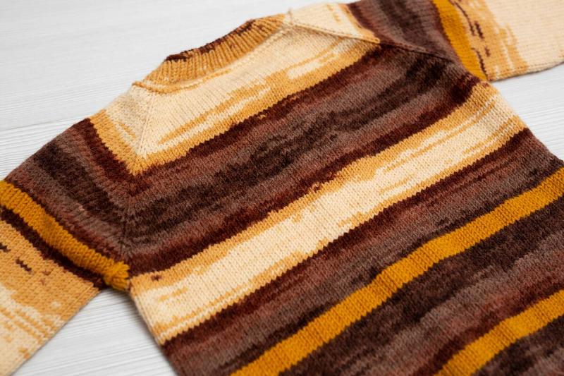 Sweater laying flat on a table. 