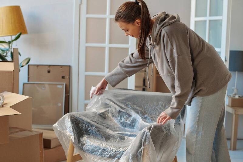Woman unpacking a chair after a move.