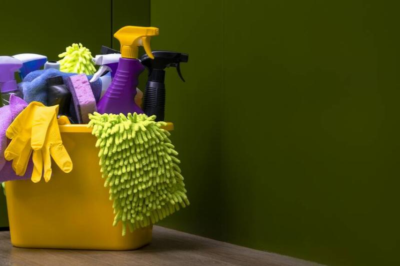 Chemical cleaners in a yellow plastic bin. 
