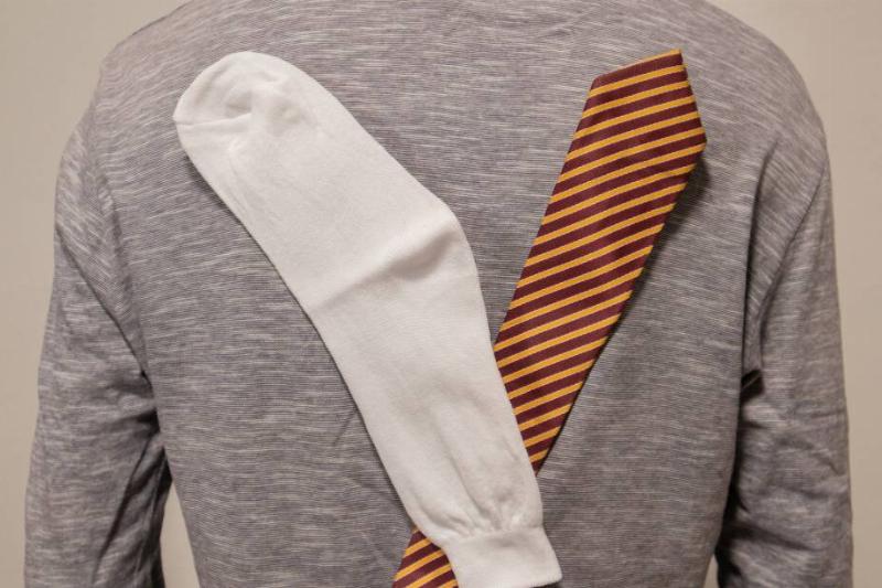 A tie and sock stuck to a shirt with static. 