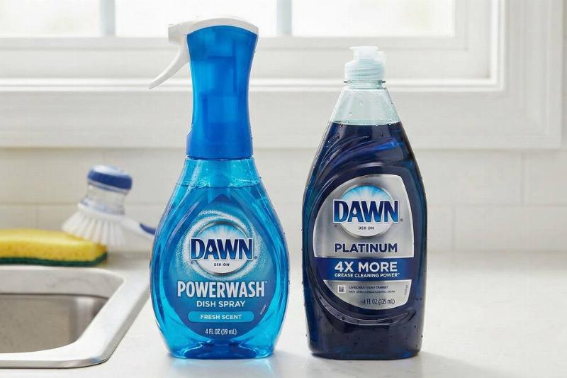 A bottle of Dawn Powerwash beside a bottle of Dawn Platinum dish soap. 