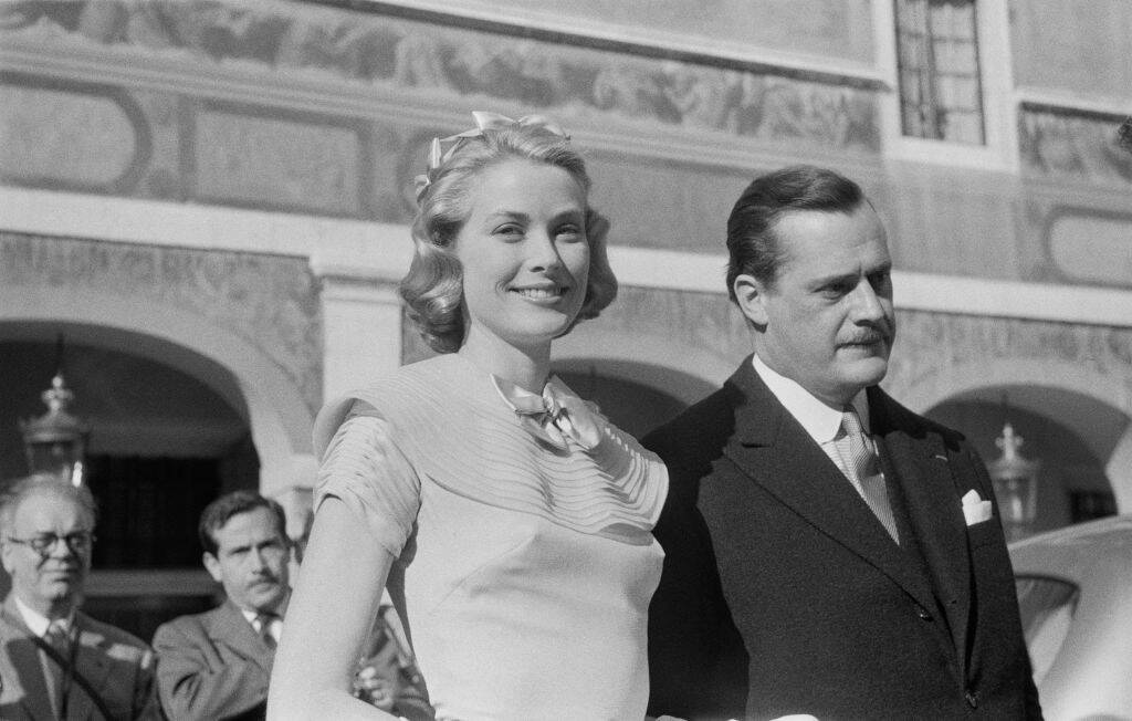 Grace Kelly and Prince Rainier standing outside together