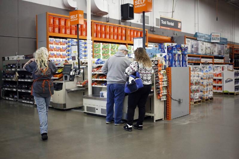 Customers use a self-checkout lane at a Home Depot.