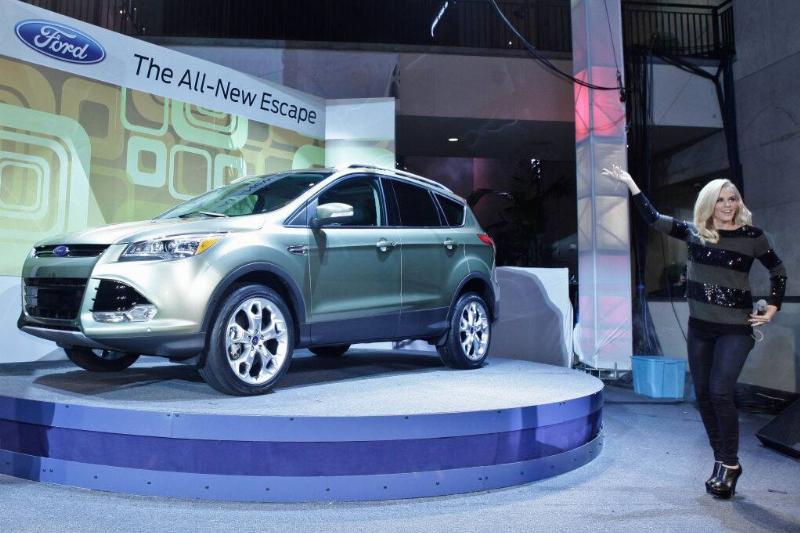 Jenny McCarthy holding her hand toward a green 2013 Ford Escape