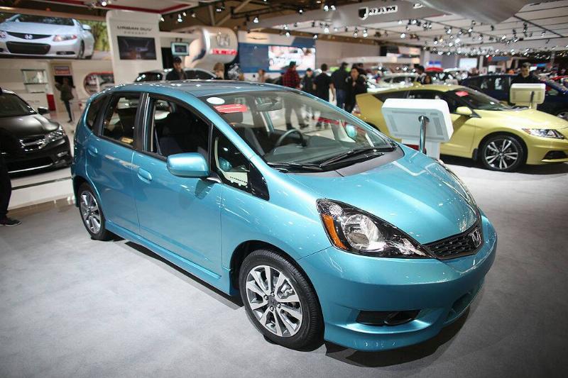 Blue 2013 Honda Fit on display in a large exhibition room