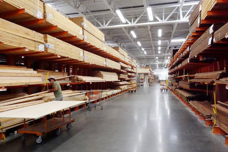 A customer shops in the lumber section of a Home Depot store.
