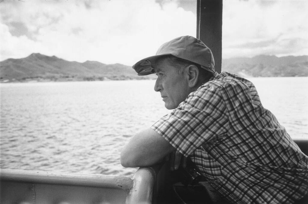 Leland Hayward looking out the side of a boat