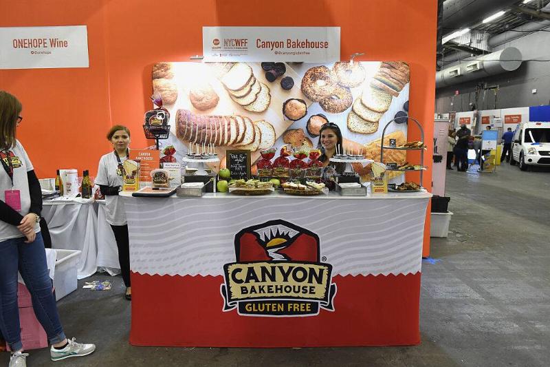 Three women standing at a Canyon Bakehouse booth