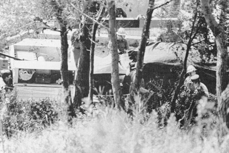Emergency responders standing in a wooded area