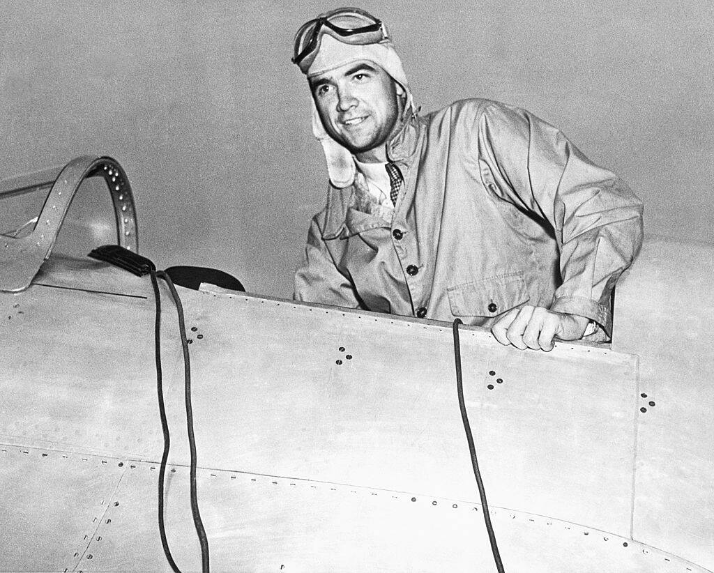Howard Hughes sitting in the cockpit of an aircraft